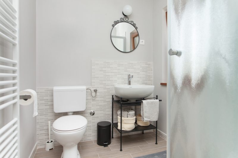 small bathroom with oval mirror
