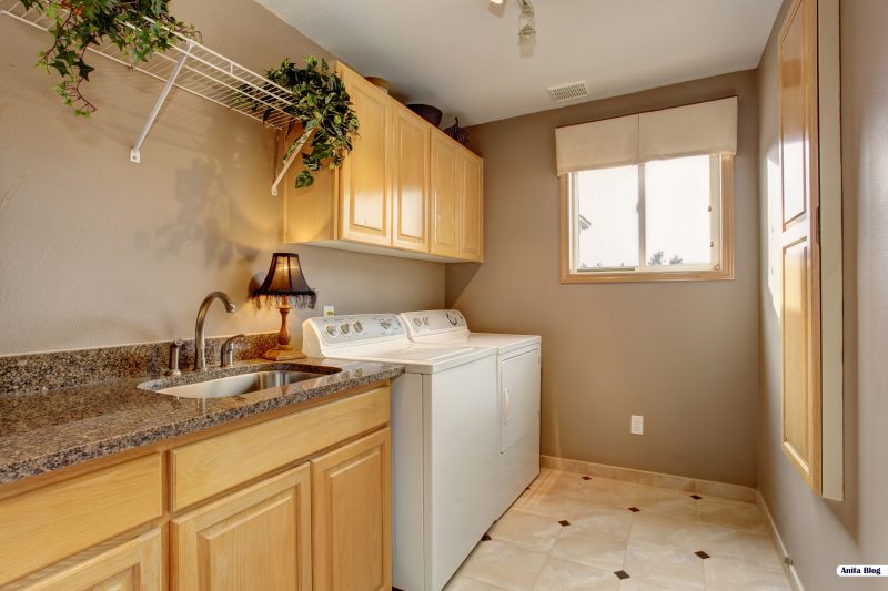 Traditional laundry room with tile floor