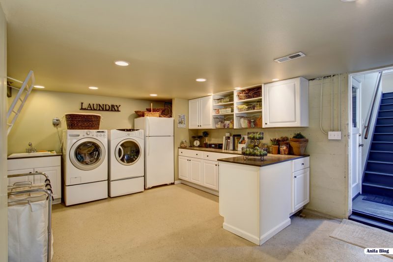 Large laundry room with appliances and white cabinets design