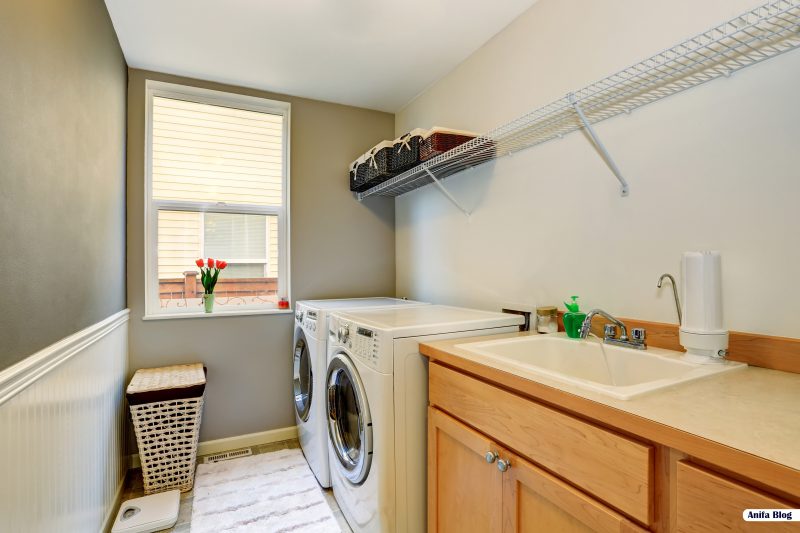 Laundry room with wood cabinets