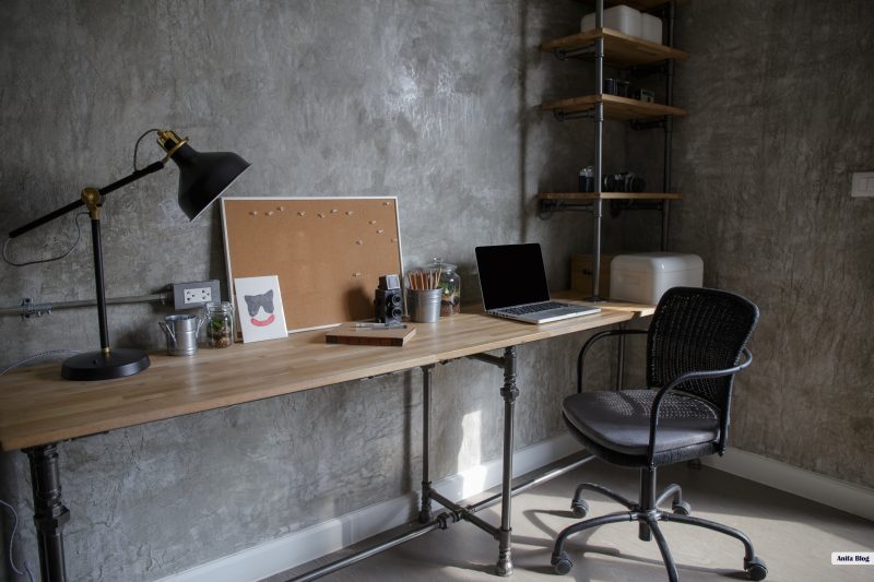 Home office interior in loft space with wooden table